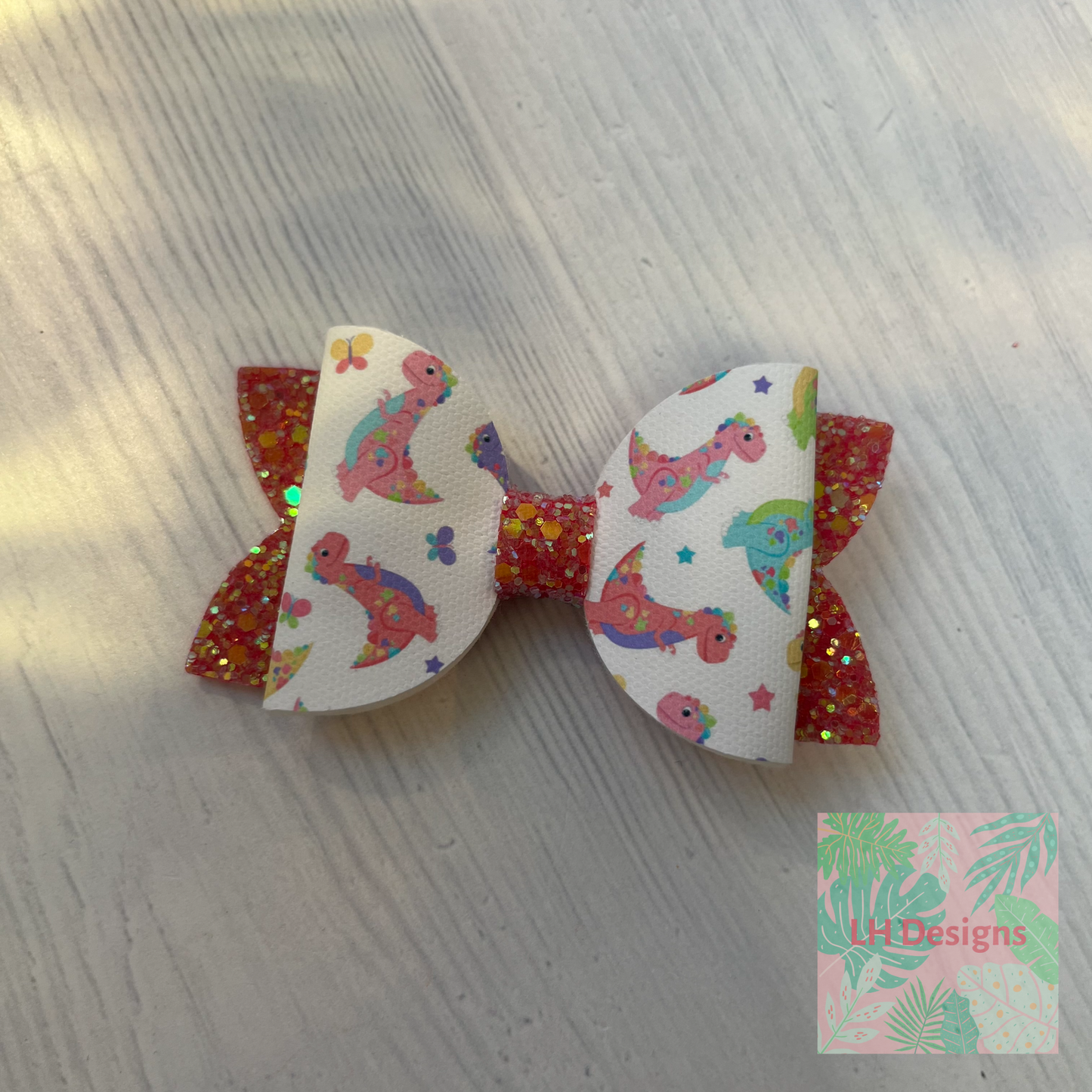 Coral Dinosaur Hair Bow